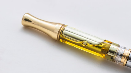 Cannabis Oil Extract In Cartridge On An Electronic Vape Pen