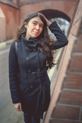 Portrait of a city girl in a black jacket. Girl walking in the fresh air