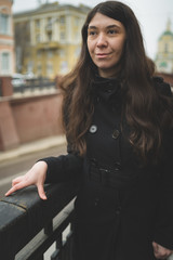 Portrait of a city girl in a black jacket. Girl walking in the fresh air