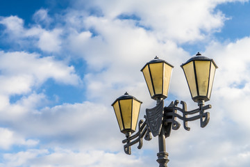 Street lamp. Photo against the blue sky.