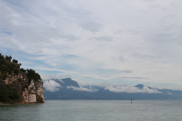 Low white clouds on lake Garda Sirmione Italy