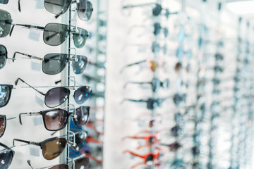 Eyeglasses and sunglasses showcase in optic shop