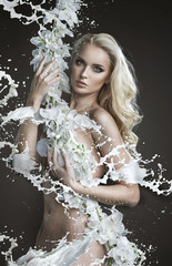 Nude blond lady holding white flower plant