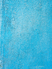 old blue paint in cracks on the wooden wall