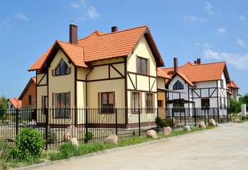View of the street in the cottage settlement. Stylization of  timber-framing style