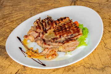 Boneless roast chicken. Garnished with onion chips, cherry tomatoes, lettuce leaves and pomegranate sauce.
