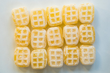 flat lay yellow butter candy cubes, typical sweets of The Netherlands