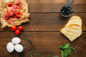 Raw meat in seasoning, olives, herb and eggs