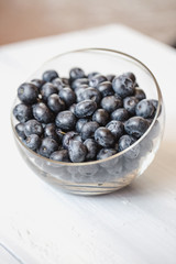 Plate with blueberries on a wooden table.