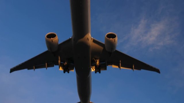 Close up of a big jumbo jet airplane or airliner flying low over head or landing