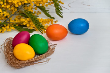 Colorful easter eggs with flowers on white wooden background Happy Easter concept
