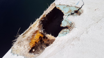 Closeup of a damaged fiberglass boat