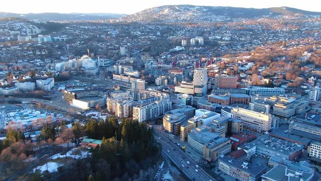 Aerial zooming out shot of Skoyen area and e18 seen towards Holmenkollen in Oslo, Norway