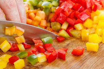 Stock up on winter food. Chef cutting bell pepper.