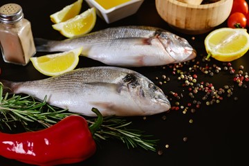 Fish seafood dorado, raw food on black background,  background.