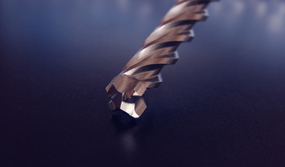 A heavy professional metal drill bit for concrete drilling and demolition on a beautiful background. Tool. Drill for drilling concrete stone and brick. Close up.