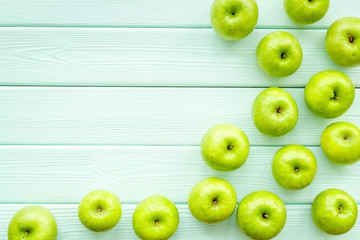 green apples for organic summer food pattern on light wooden background top view mockup