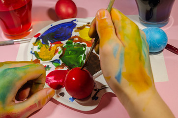 colored hands painting easter eggs