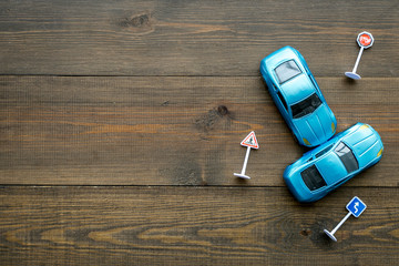 Car insurance concept with car toys on wooden background top view copyspace