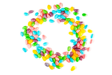 Easter colorful eggs candy on white background, copy space. Easter wreath