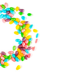 Easter colorful eggs candy on white background, copy space. Easter wreath