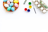 eggs with colorful paint for easter tradition on white background top view mockup