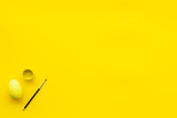 eggs with colorful paint for easter tradition on yellow background top view mockup
