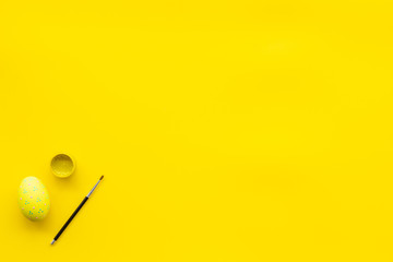 eggs with colorful paint for easter tradition on yellow background top view mockup