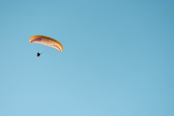 Parachutist in the blue sky