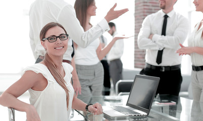 young business woman sitting in front of open laptop