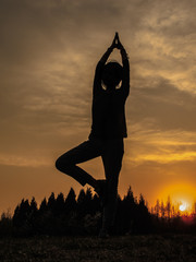 young woman yoga with sunset in nature 