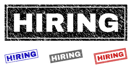 Grunge HIRING rectangle stamp seals isolated on a white background. Rectangular seals with grunge texture in red, blue, black and gray colors.