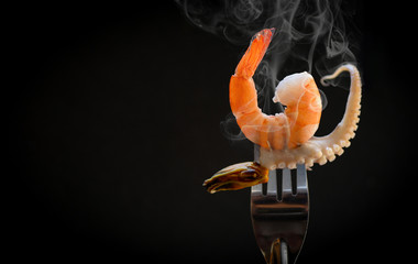 Shrimp on fork / Cooked seafood shrimps prawns mussel squid tentacles of octopus ocean gourmet...