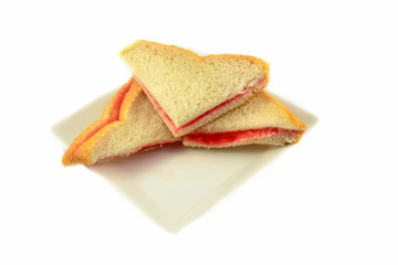 Sandwich homemade with strawberry jam in bread for breakfast isolated on white background