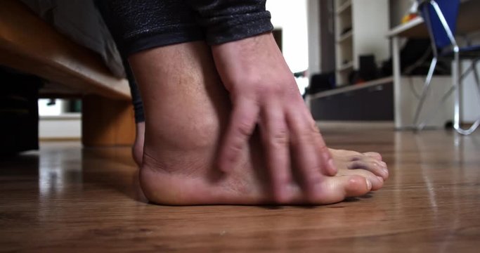 Men leg after a sprained ligament injury close up walk