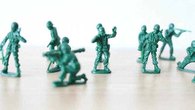 Miniature toy soldiers on wooden toy