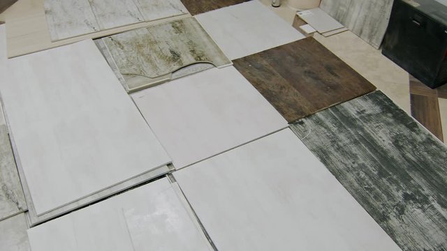 selected ceramic tiles are lying on floor in warehouse, panoramic view