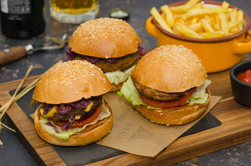Homemade delicious three mini burgers: beef, chicken, vegan served with sauce and french fries. Homemade mini burger sliders. 