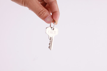 hand hold a home key isolated on white