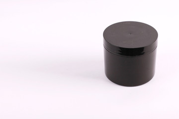 Black cosmetic containers on white background