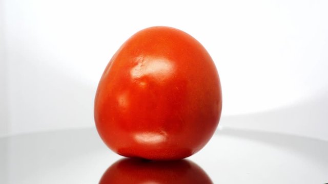 Spoiled tomato close up on white background