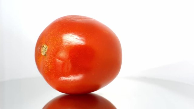 Spoiled tomato close up on white background