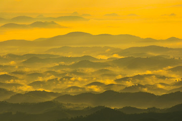 Fototapeta na wymiar Landscape mountain range with fog mist colorful sunrise in the morning cloudy