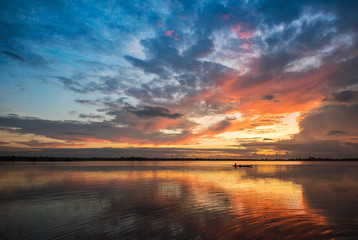 Naklejka na ściany i meble Beautiful river sky and fishing boat sunrise or sunset with colorful sky dramatic