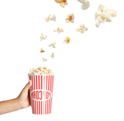 Woman holding cup with delicious popcorn on white background, closeup