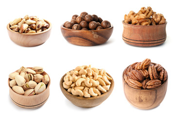 Set of bowls with different organic nuts on white background