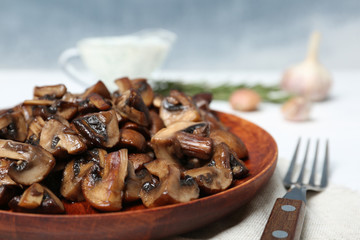 Plate of fried mushrooms on table, closeup. Space for text