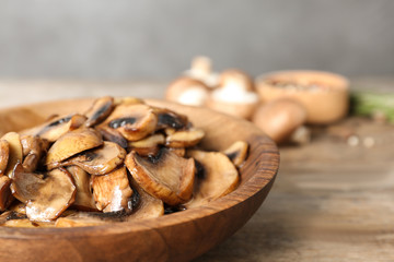 Plate of fried mushrooms on table, closeup. Space for text