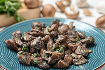 Plate of tasty fried mushrooms with sauce on table, closeup