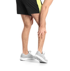 Man suffering from leg pain on white background, closeup